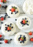Meringue nests with whipped cream and fruit