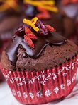 Chocolate muffins with goji berries, cranberries and fresh orange zest with dark chocolate coating